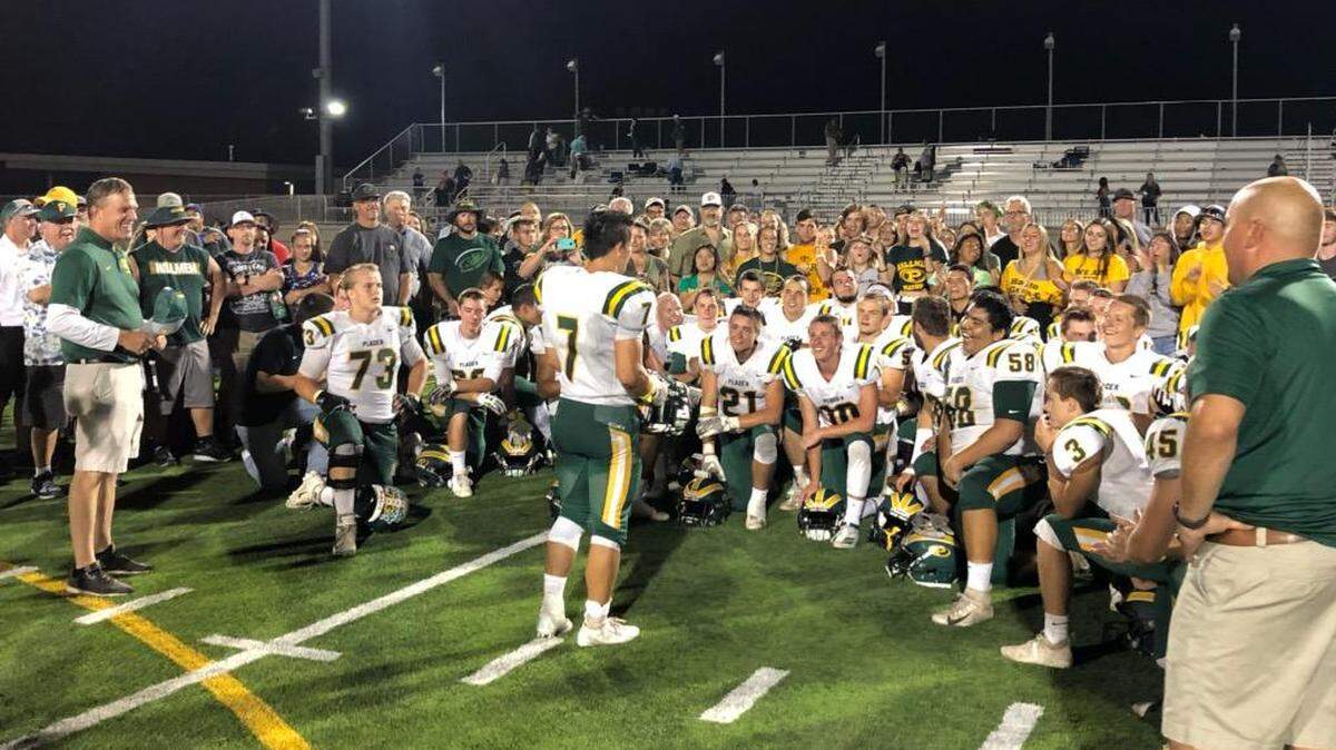 The Placer High School football team is joined by the cheering section after the Hillmen beat Vista del Lago on Friday night in Folsom.