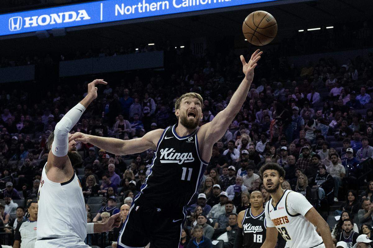 Sacramento Kings center Domantas Sabonis (11) drives to the basket against Denver Nuggets center Jonas Valanciunas (17) during a game at the Golden 1 Center on Tuesday, Nov. 11, 2025, in Sacramento.