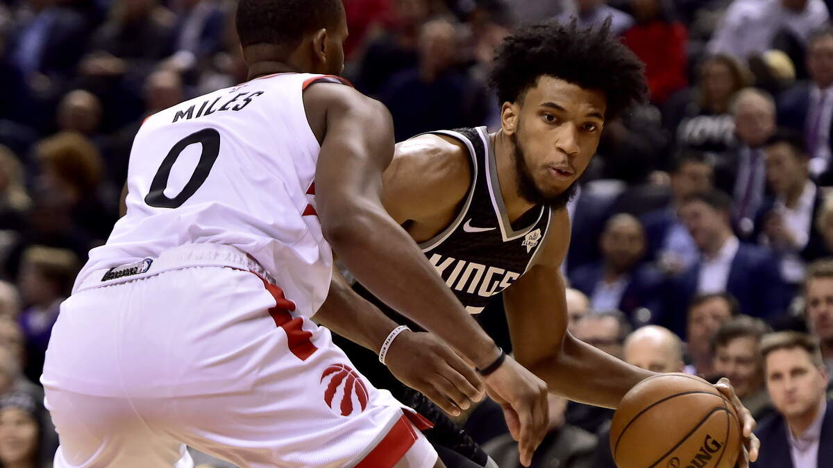 Kings forward Marvin Bagley III, right, tries to get around Toronto Raptors forward CJ Miles on Tuesday at Scotiabank Arena. Bagley took advantage of his first NBA start by scoring a career-high 22 points and grabbing 11 rebounds for his sixth double-double.