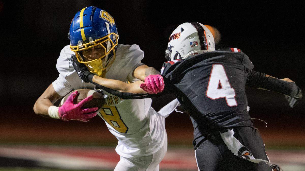 The Del Campo Cougars' Isaiah Richmond is tackled by the Bella Vista Broncos' Guillermo Perez in the first half Friday in Fair Oaks.