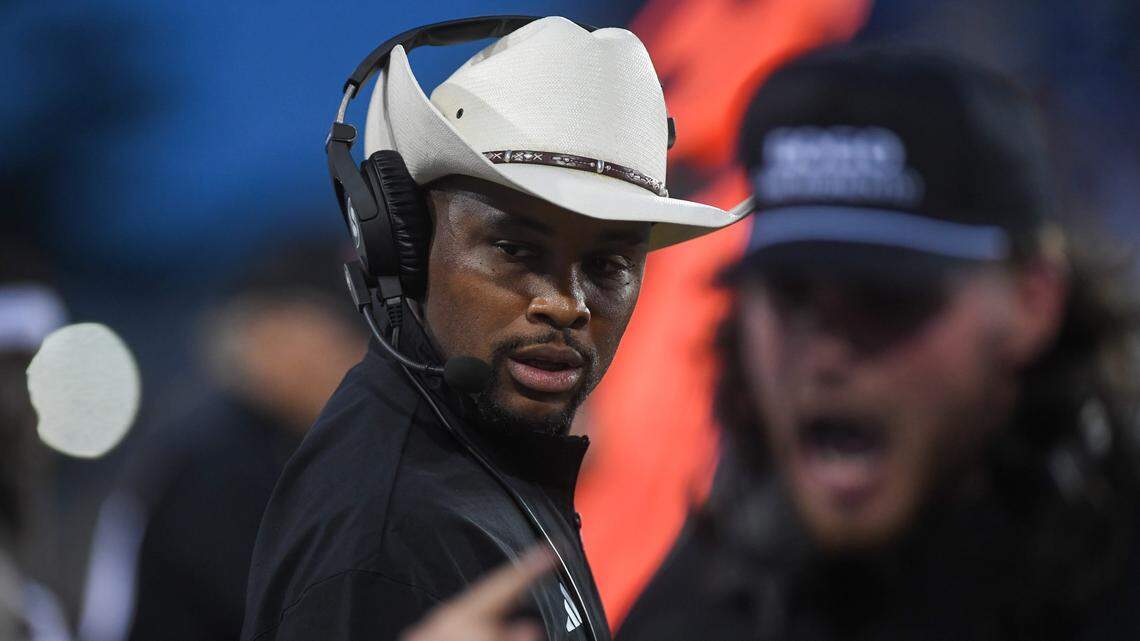 Sacramento State Hornets head coach Brennan Marion listens an assistant coaches shout to players during the season opener against South Dakota State on Saturday in Brookings, S.D.