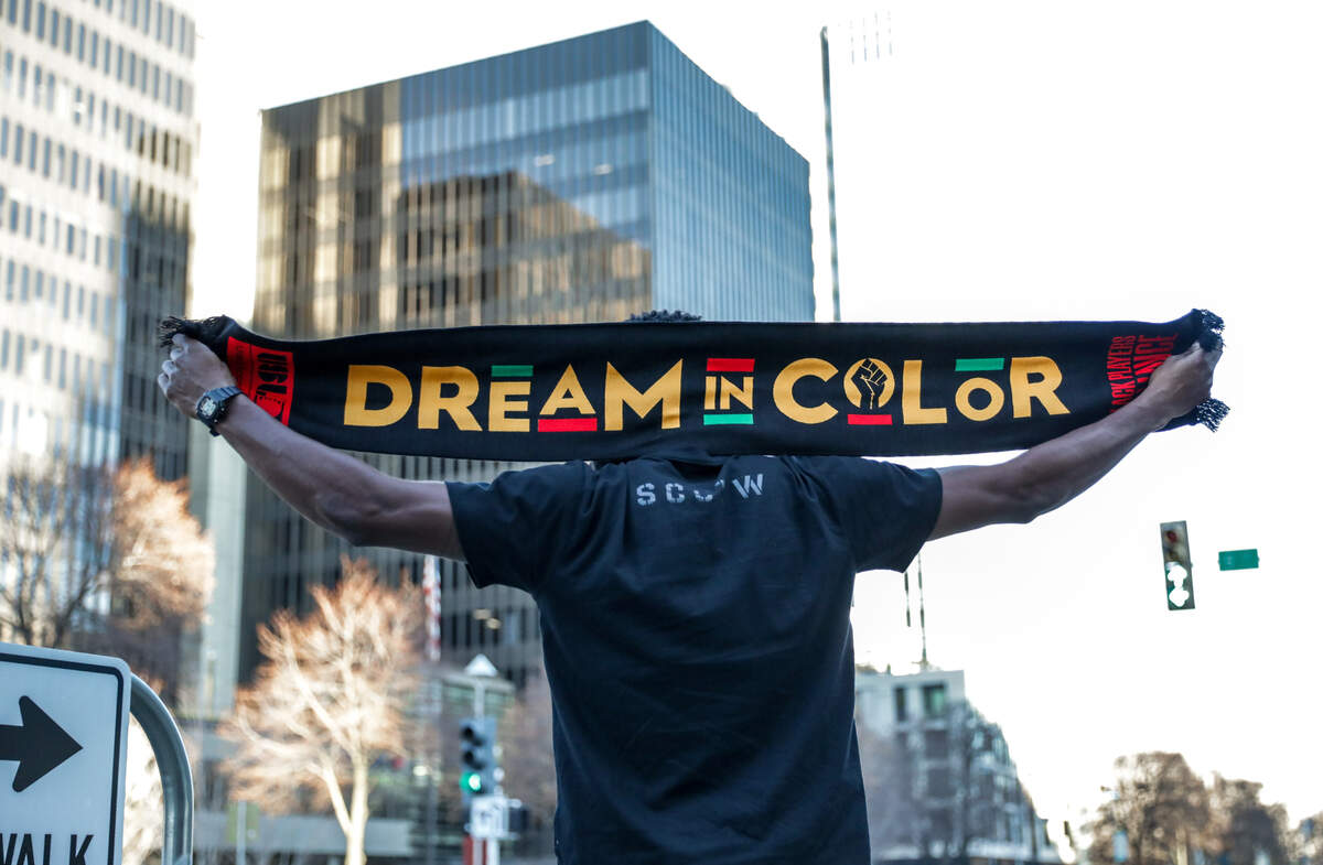 Sacramento Republic player Duke Lacroix poses with a scarf he helped design to benefit charities.