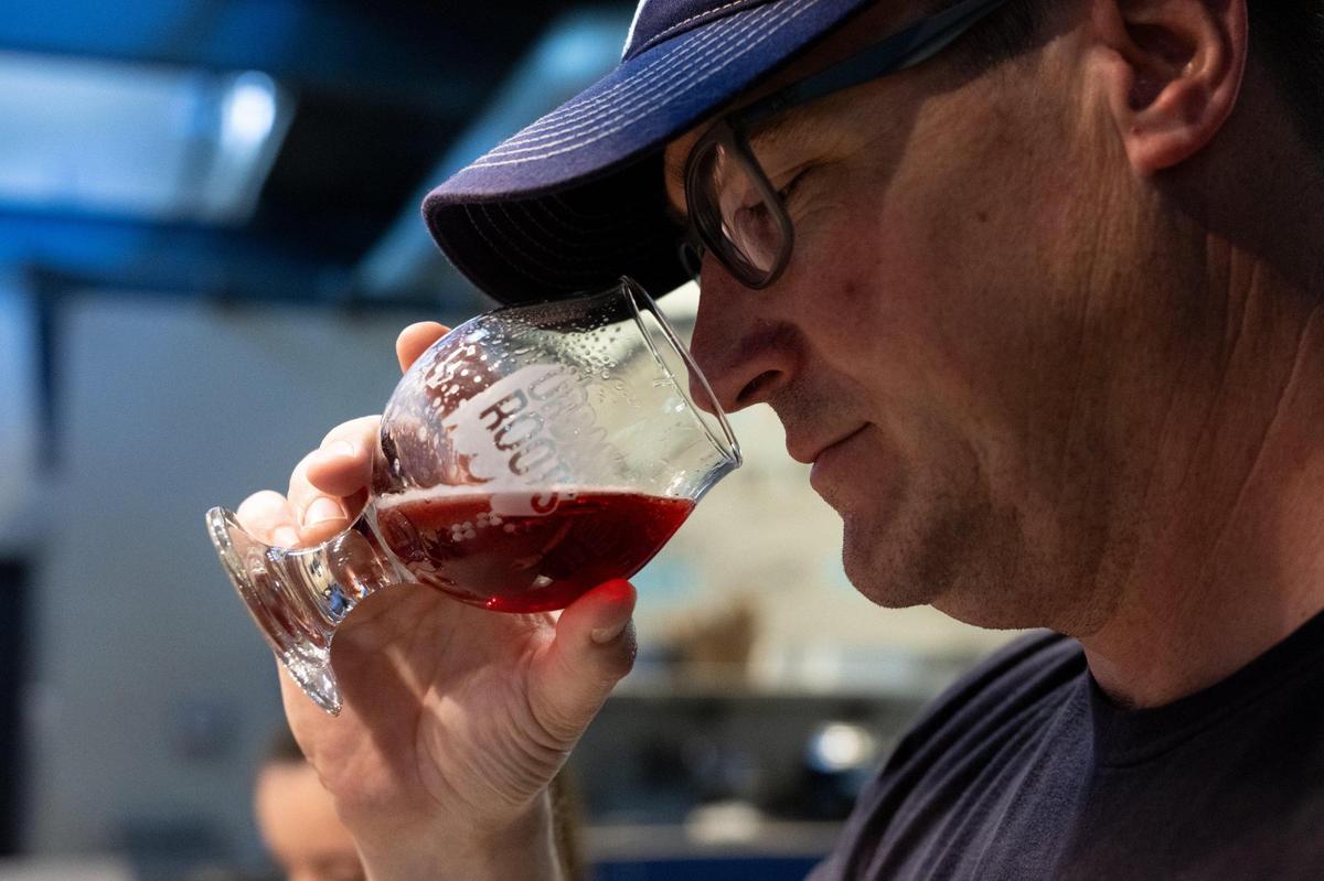 Urban Roots brewer Peter Hoey sniffs the bouquet of Blend-In, a fruited sour beer, on Monday, April 14, 2025, at the Sacramento brewery.