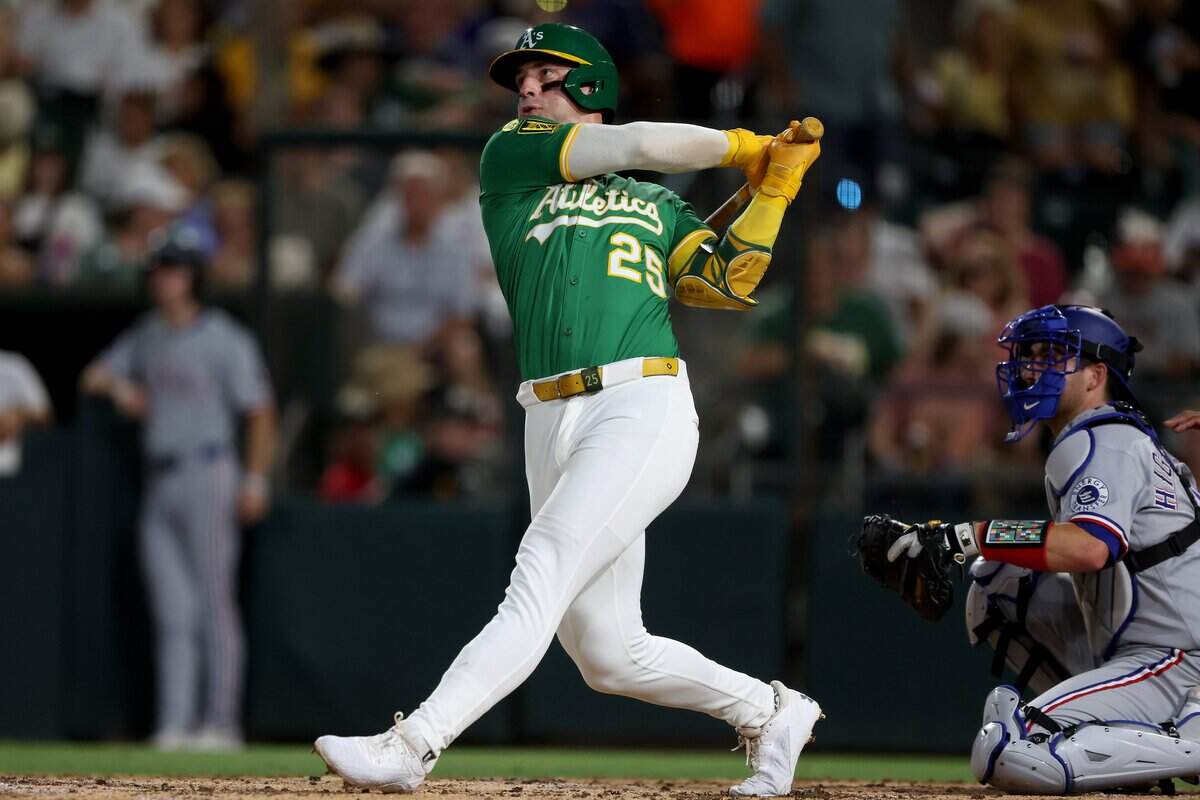 Aug 30, 2025; West Sacramento, California, USA; Athletics designated hitter Brent Rooker (25) hits a solo home run against the Texas Rangers during the third inning at Sutter Health Park. Mandatory Credit: Dennis Lee-Imagn Images