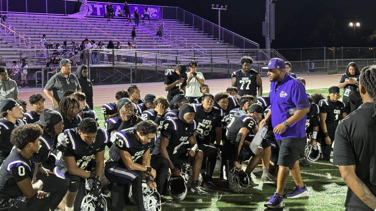 Franklin High coach Joseph McCray addresses his Wildcats team after a win over Elk Grove High on Friday at Cosumnes Oaks High.
