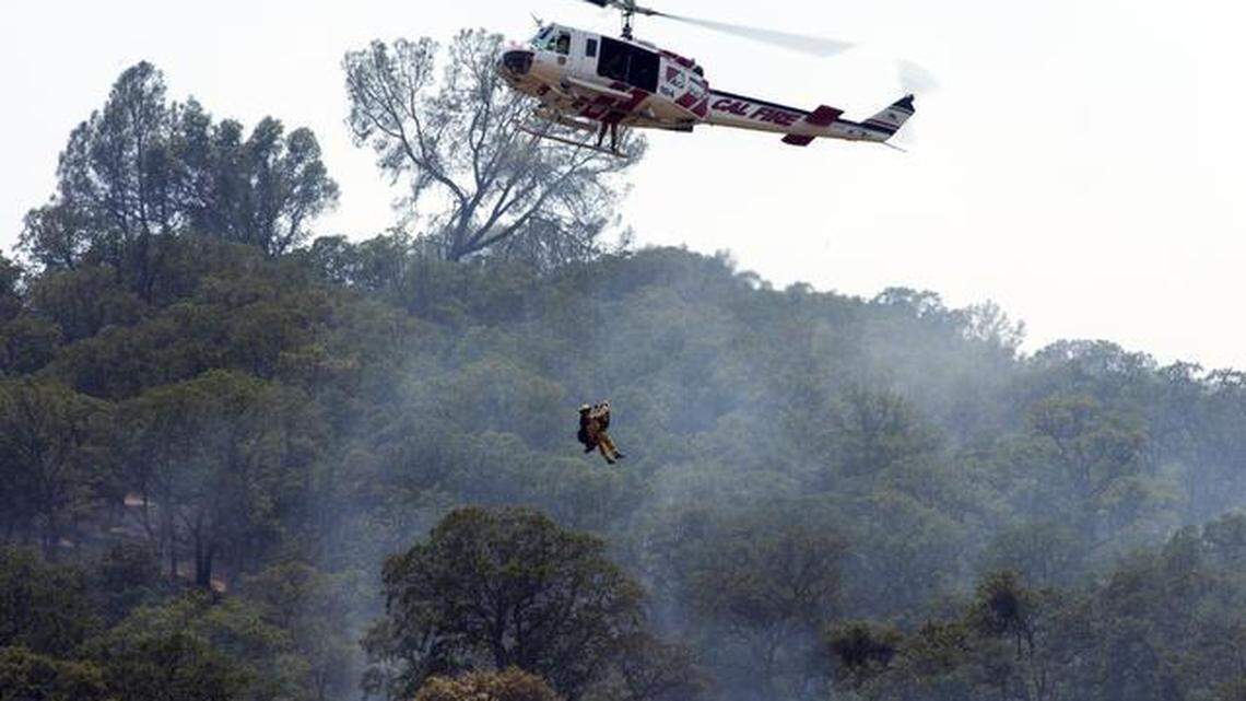 Cal Fire airlift an injured bulldozer operator from the Monticello Fire on the east side of the mountain Sunday July 6, 2014 near Winters.
