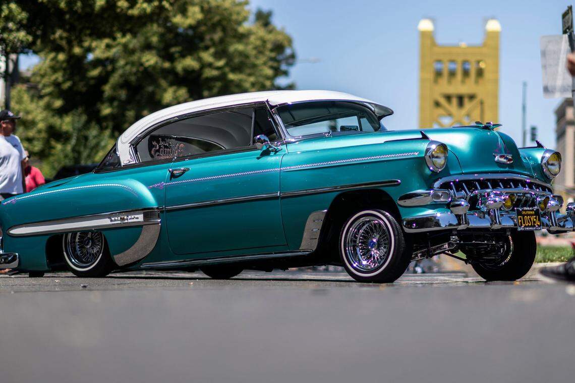 A 1954 Chevy Bell Air is parked on Capitol Mall in front of the Tower Bridge during the California Lowrider Holiday Celebration on Sunday.