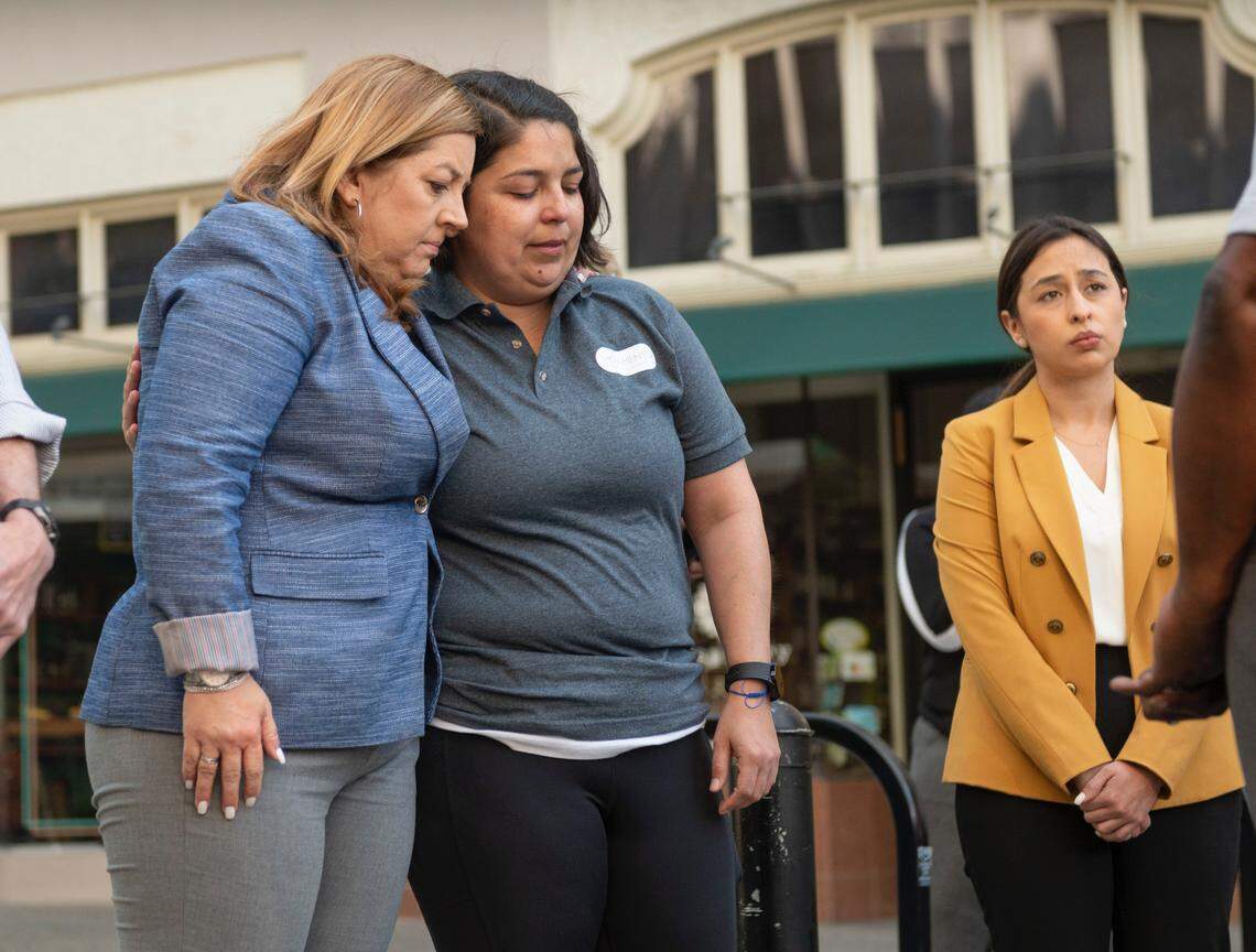 Sacramento City Council members Angelique Ashby and Katie Valenzuela comfort each other during a press conference Sunday, April 3, 2022, as the mayor speaks to the media following the mass shooting in downtown Sacramento that left six people dead and 10 more wounded.
