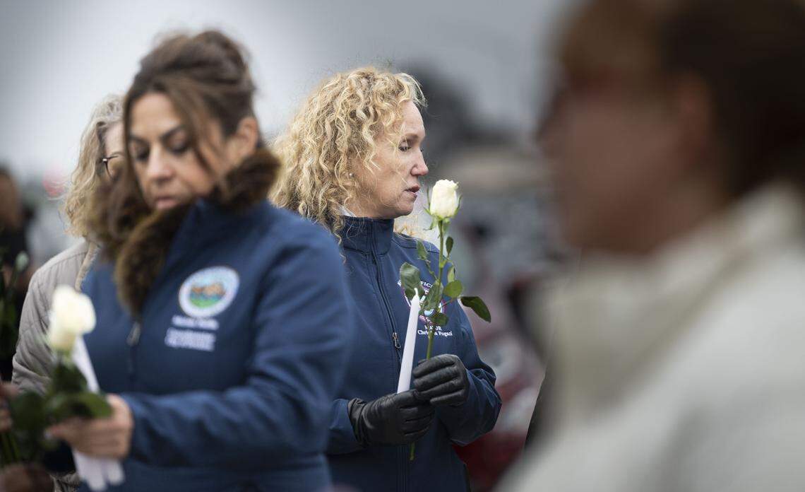 Stockton Mayor Christina Fufgazi holds a white rose during a vigil on Sunday after a mass shooting near Stockton.