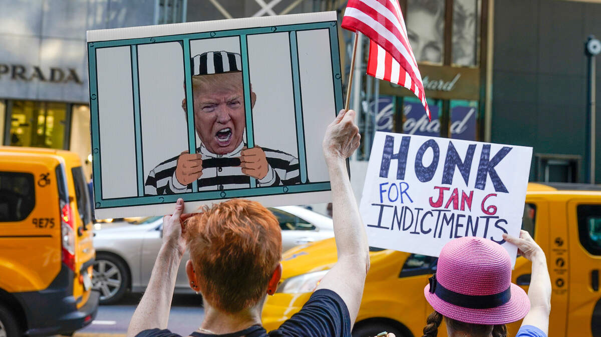 Protesters stand in front of Trump Tower in New York, Tuesday, Aug. 9, 2022. The FBI search of Donald Trump’s Mar-a-Lago estate marked a dramatic and unprecedented escalation of the law enforcement scrutiny of the former president, but the Florida operation was just one part of one investigation related to Trump and his time in office.