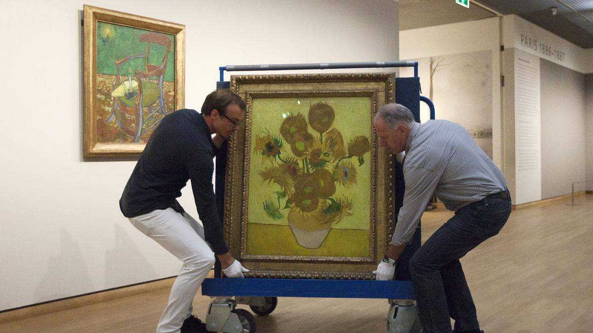 Curators are putting Vincent van Gogh’s famous “Sunflowers” painting onto a felt-lined carrier trolley at the Van Gogh Museum in Amsterdam, Netherlands, Sunday, Sept. 23, 2012.