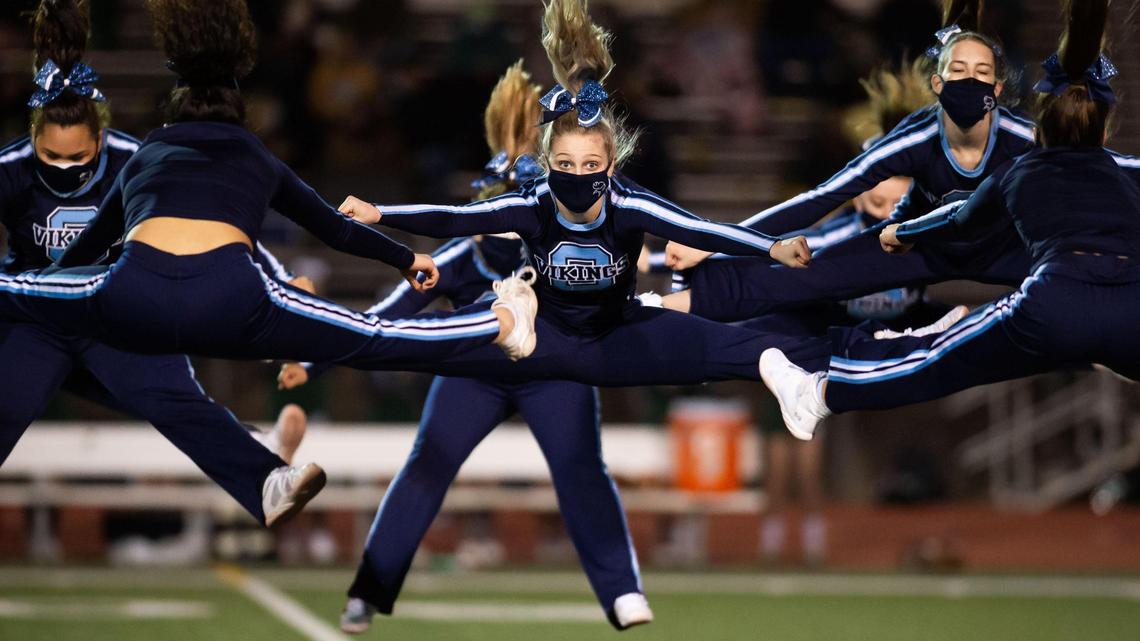 The Oakmont High School cheerleaders perform during halftime of the Vikings’ 15-7 win over Ponderosa High School during the opening football game of the short spring Friday, March 12, 2021, at Oakmont in Roseville.