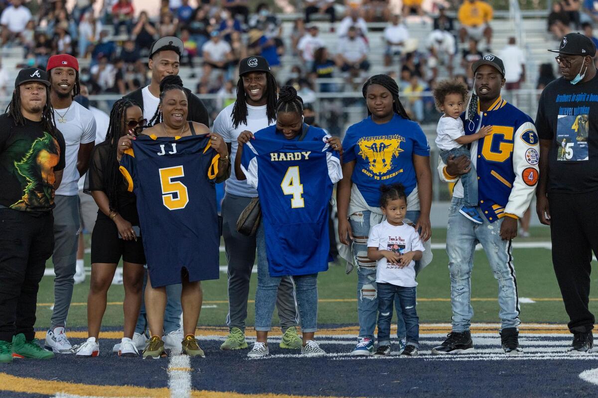 10. As mothers of sons killed by violence, Nicole Clavo, left, mother of JJ Clavo, and Miasha Brown, mother of Larry “Pooter” Hardy, share a laugh as they trade back their sons’ jerseys before the start of the Grant and Inderkum football game in Natomas at Inderkum High School in Sacramento on Monday, Aug. 30, 2021. Nicole Clavo lost her son to gun violence and Miasha Brown lost hers to domestic abuse.