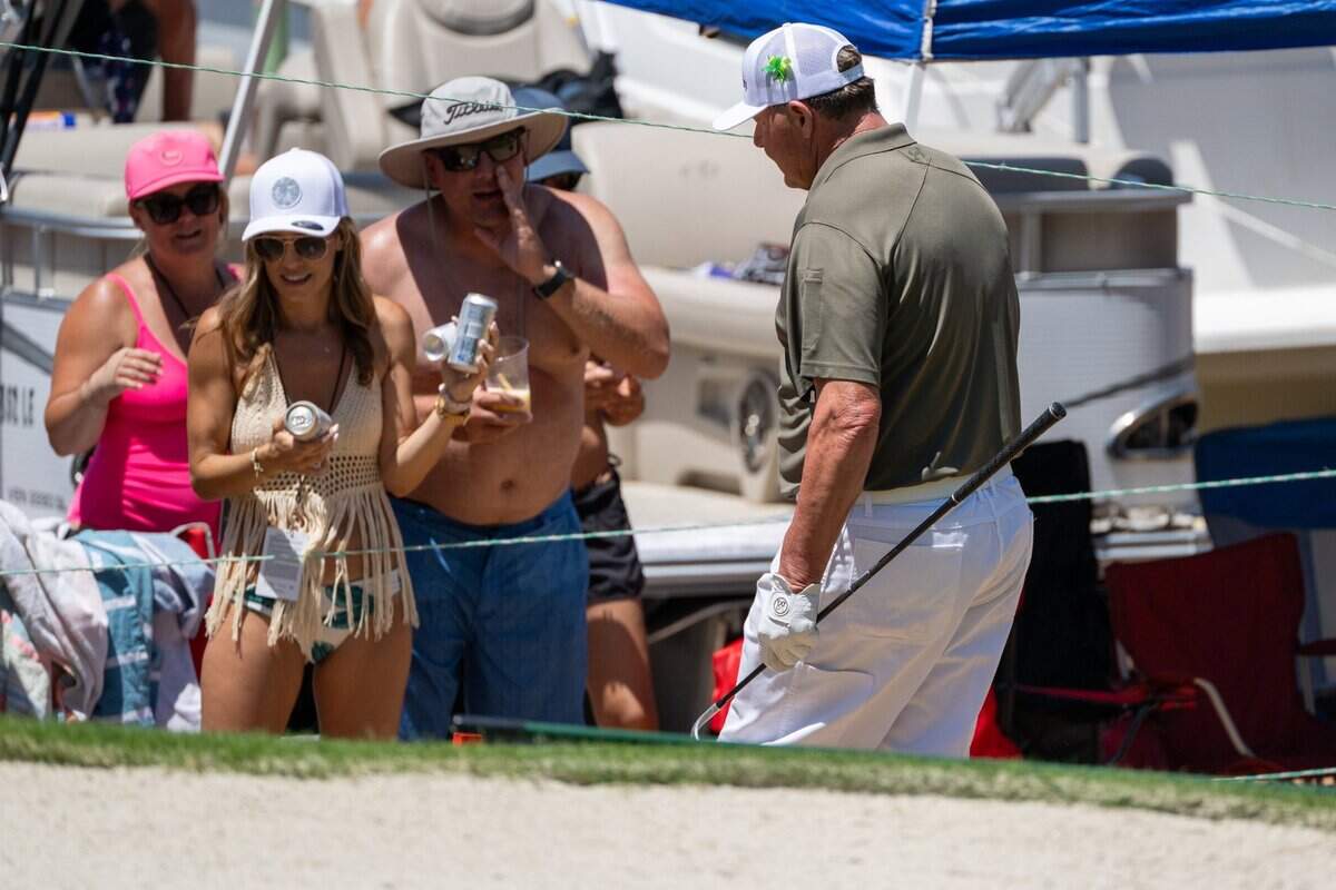 Retired baseball player Roger Clemens walks by fans looking for his ball along Lake Tahoe on the 17th hole during the American Century Championship celebrity golf tournament at Edgewood Tahoe Resort in Stateline, Nev., on Friday, July 11, 2025.