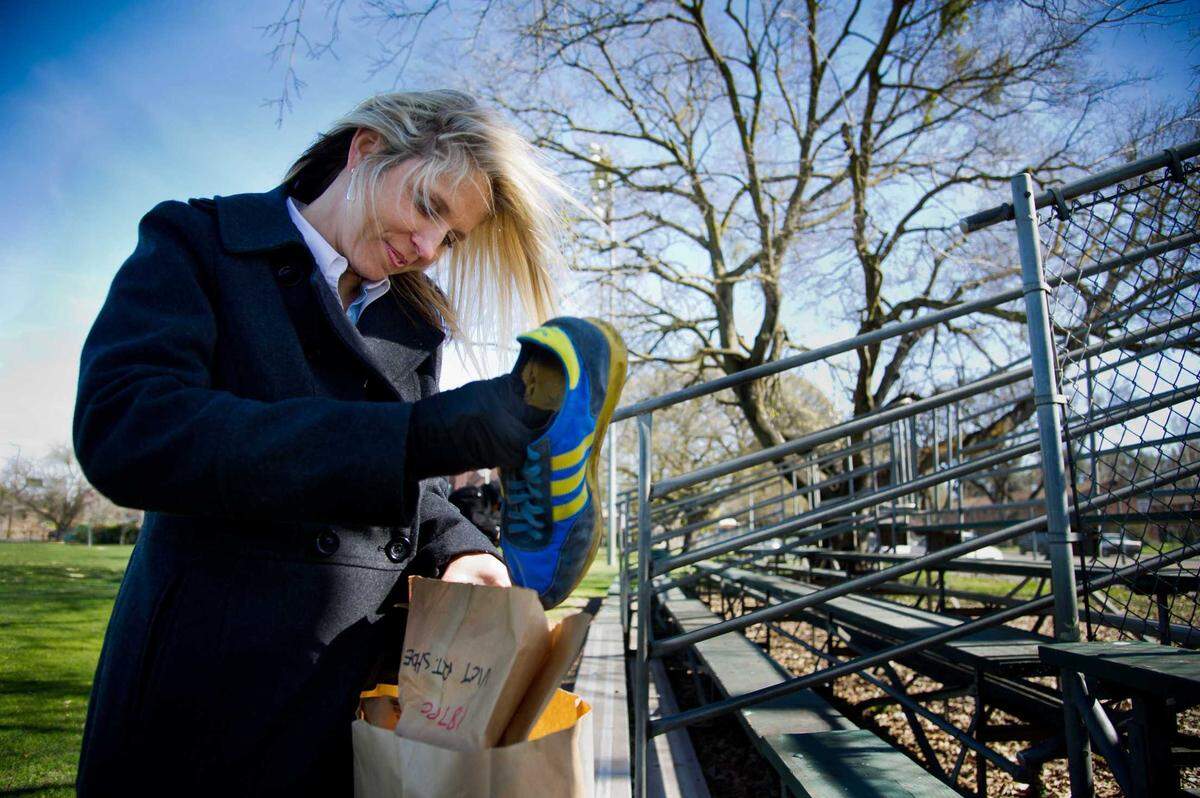 Sacramento police Officer Laura Peck holds blue Adidas tennis shoes on February 23, 2011 with gold stripes that a John Doe was found wearing at the time of his death on Jan. 17, 1980. The man has been identified 44 years later, and his family is seeking the public’s help to identify his killer.