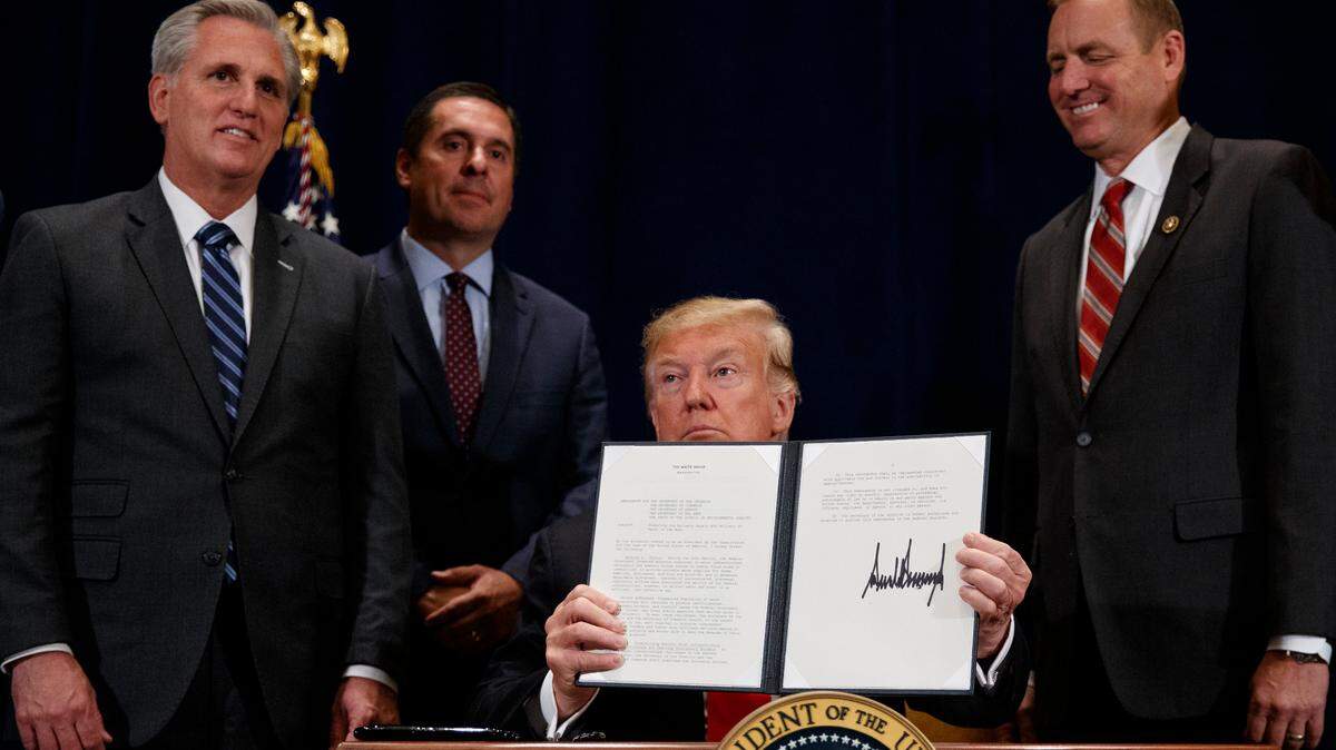 President Donald Trump holds up a “Presidential Memorandum Promoting the Reliable Supply and Delivery of Water in the West,” after signing it during a ceremony, Friday, Oct. 19, 2018, in Scottsdale, Ariz. Standing behind the president from left, Majority Leader Kevin McCarthy, R-Bakersfield, Rep. Devin Nunes, R-Tulare., and then Rep. Jeff Denham, R-Modesto.