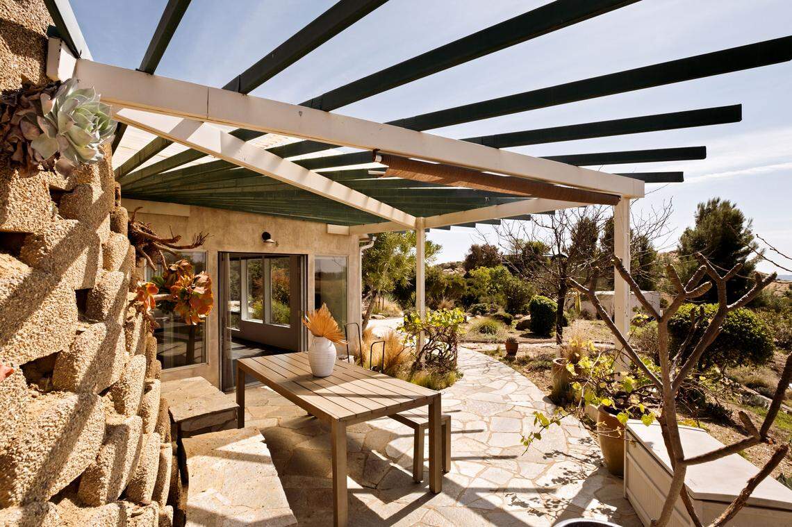 The visionary three-bedroom, two-bathroom Earthship integrates sustainability with luxury. The home utilizes passive solar heating and the earth’s natural insulation to achieve near-total energy self-sufficiency.