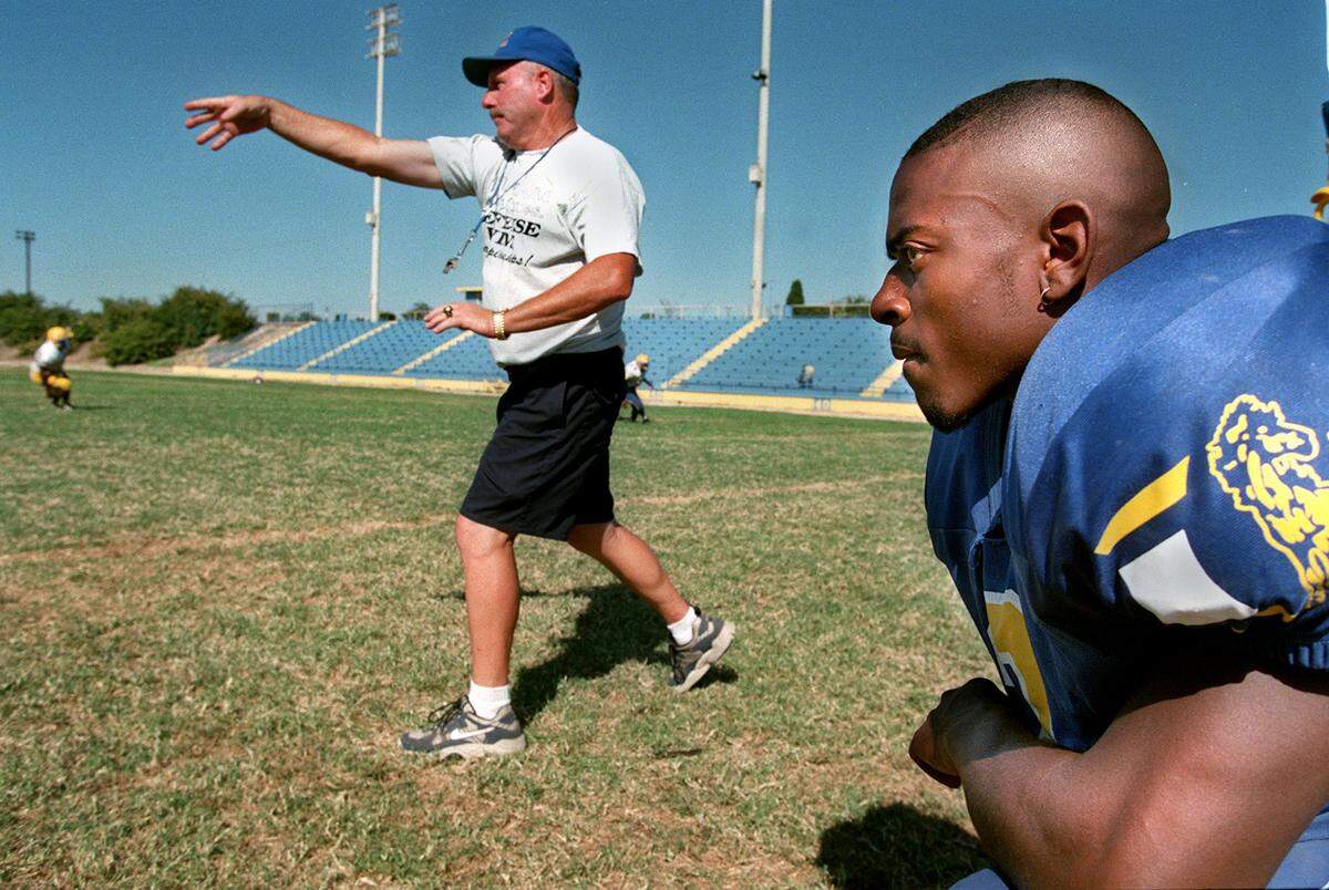 Grant High School leading rusher Onterrio Smith, who later played for the Minnesota Vikings, watches during practice as head coach Mike Alberghini goes through a drill on Sept. 4, 1997.