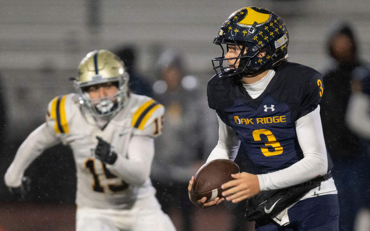 Oak Ridge Trojans quarterback Joaquin Graves-Mercado (3) runs a keeper for a short gain as Turlock Bulldogs’ Dominick Luna (15) pursues in a Sac-Joaquin Section semifinal playoff game on Friday.