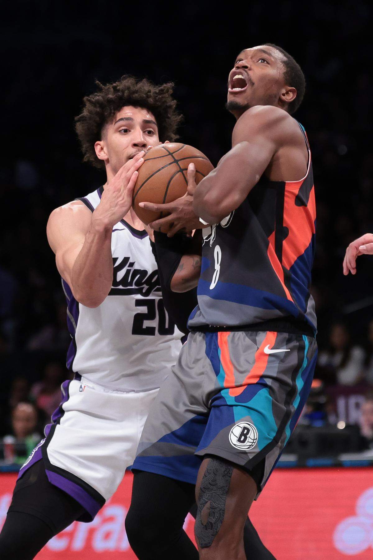 Brooklyn Nets guard Lonnie Walker IV (8) is fouled by Sacramento Kings guard Colby Jones (20) during the second half Sunday, April 7, 2024, at Barclays Center in Brooklyn, New York.