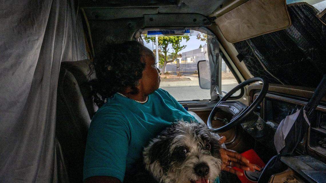 Rosita Howard, 45, holding her dog Jack, looks out from her RV parked on Winona Way at a planned “Safe Stay” parking lot in 2023. While Black Californians make up 7% of the state’s population, about 1 in 4 homeless Californians are Black, according to a UCSF study.