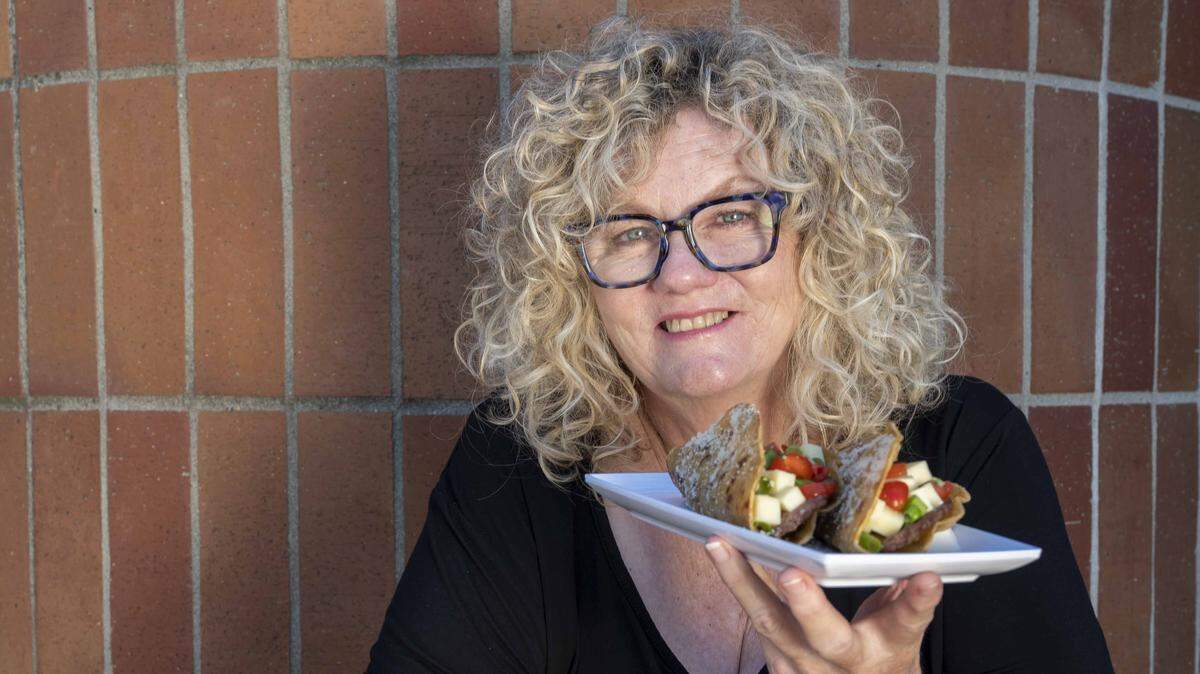Karen Knudson-Freeman of Jimboy’s Tacos poses with a plate of Cousin Jack’s Tacos on March 17, 2023, in Folsom. Knudson-Freeman died April 20, 2026, family said.