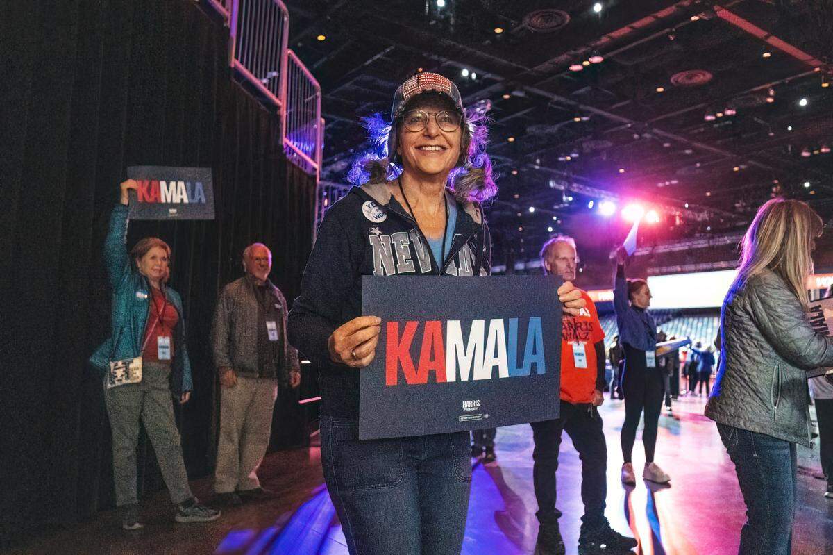 Amy Levy of Reno welcomes rally attendees with a “Kamala” sign before the arrival of Democratic presidential candidate Vice President Kamala Harris at a campaign stop at the Reno Events Center on Thursday, Oct. 31, 2024. Amy Levy of Reno welcomes rally attendees with a “Kamala” sign before the arrival of Democratic presidential candidate Vice President Kamala Harris at a campaign stop at the Reno Events Center on Thursday, Oct. 31, 2024.