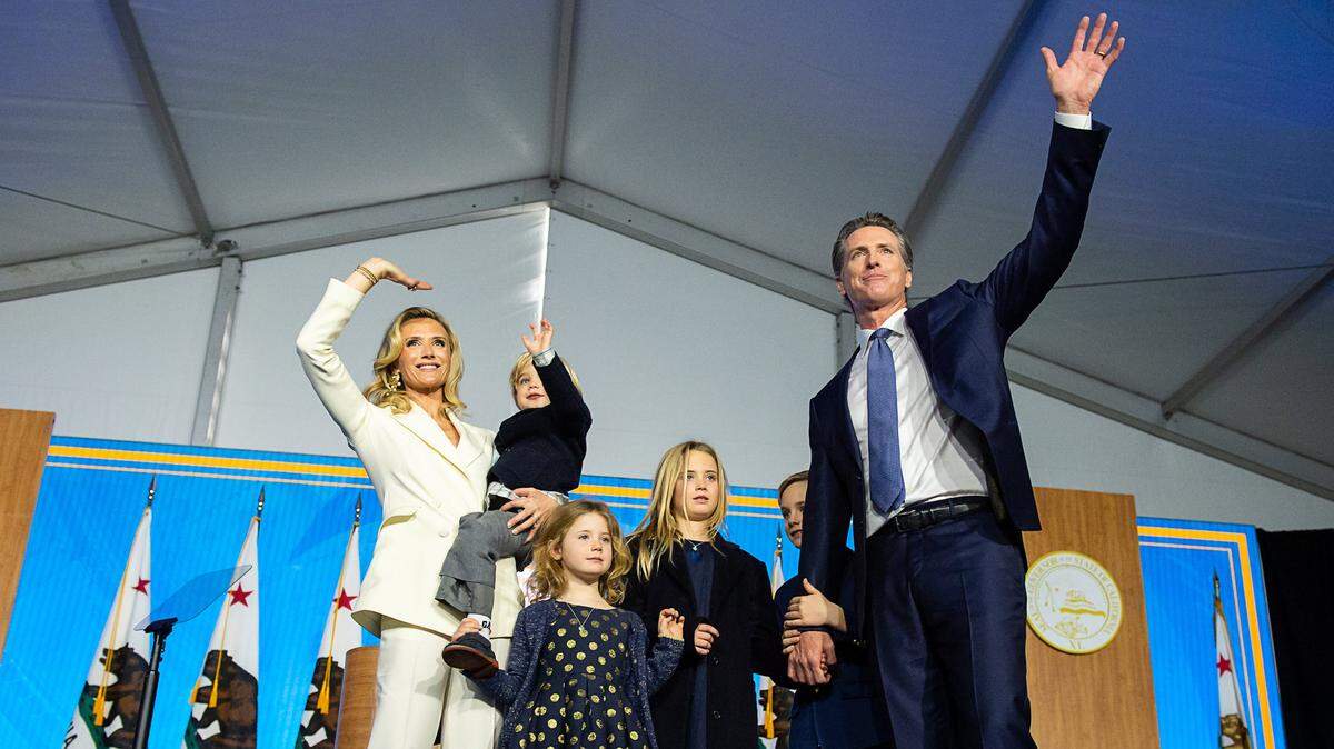 Gov. Gavin Newsom and First Partner Jennifer Siebel Newsom wave to the crowd with children Montana, 9, Hunter, 7, Brooklynn, 5, and Dutch, 2, during Newsom’s 2019 inauguration at the state Capitol.