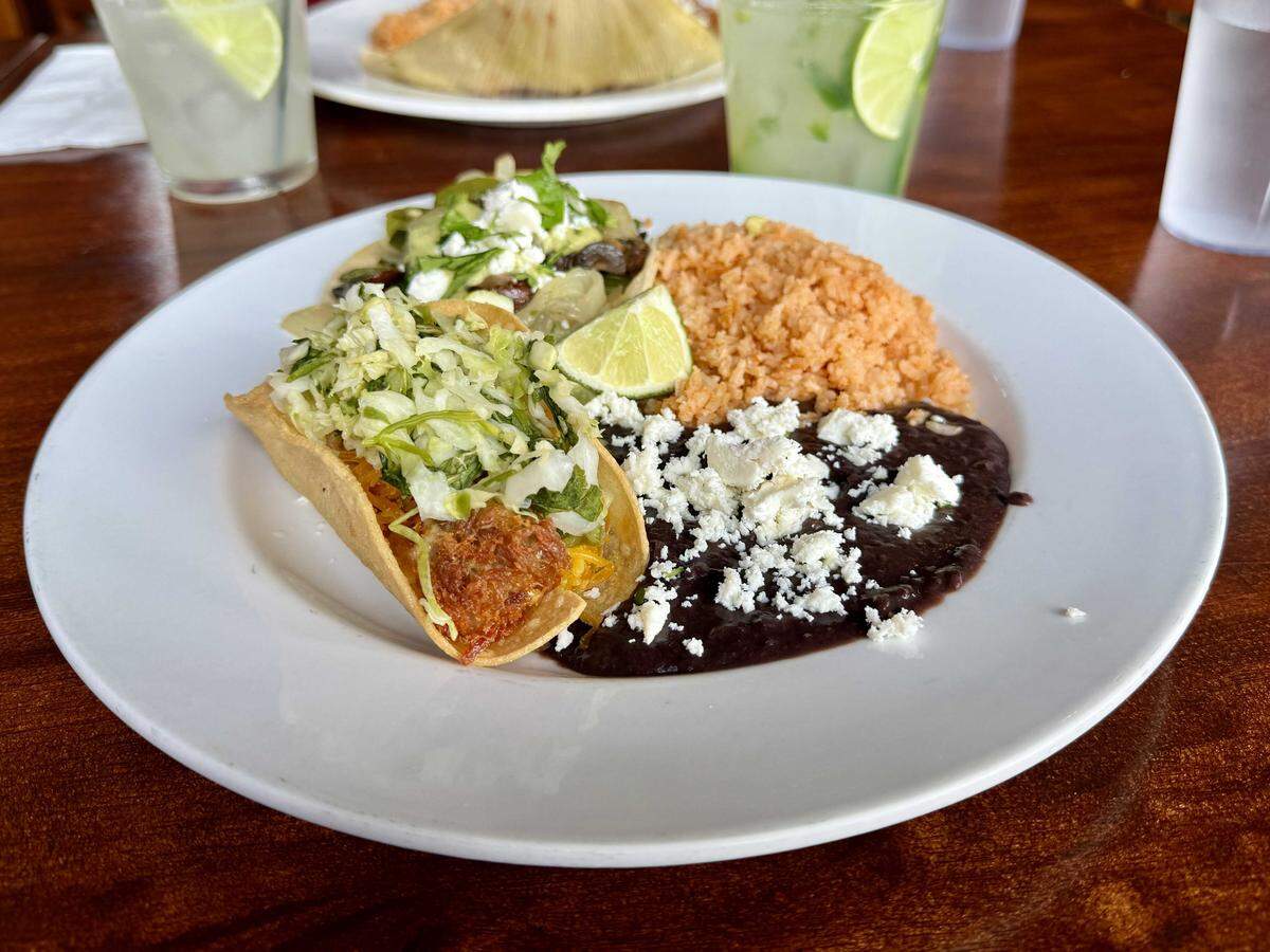 North Oak Park Mexican restaurant La Venadita house fries their crispy chicken and carnitas tacos, then tops them with cheese, lettuce and sour cream.