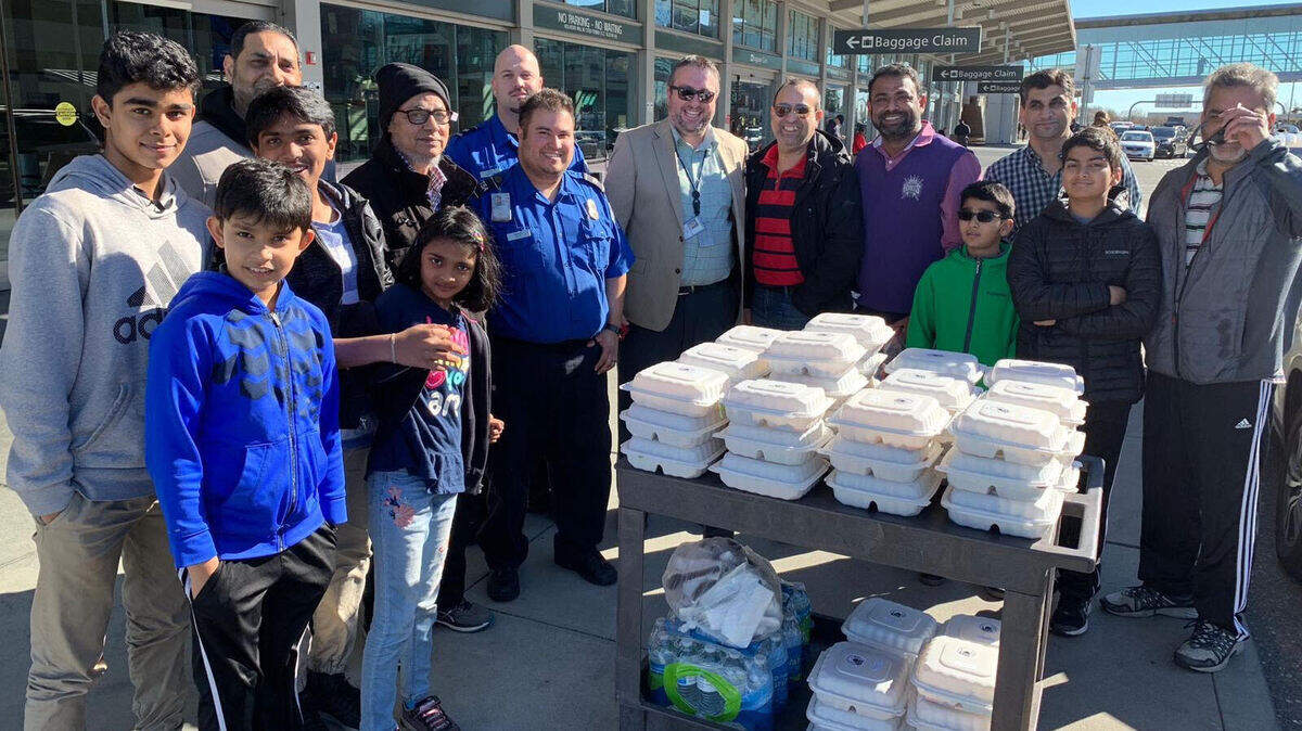 Mohammed Khader (third from center) stand s with TSA agents and the Muslim Community of Folsom volunteers outside of the Sacramento International Airport, Jan. 21, 2019. His group donated 100 meals to TSA officials at SMF.