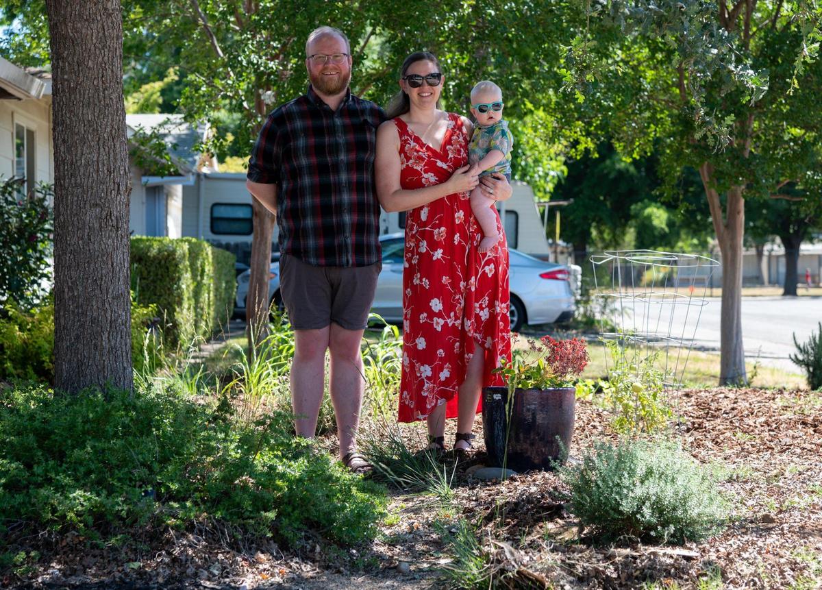 Jack and Rebecca McKeon with son, Gordon, stand in their drought-tolerant front yard in Sacramento ealier this month. The couple removed their front lawn during a DIY project and planted drought-tolerant plants and vegetables.