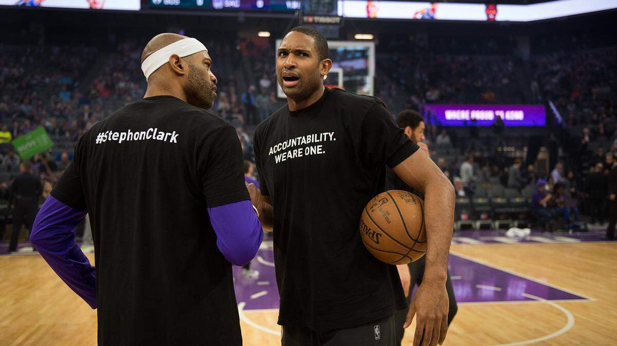 Former Sacramento Kings guard Vince Carter (15) shakes hands with Boston Celtics forward Al Horford (42) as they both wear T-shirts in honor of Stephon Clark during a game at Golden 1 Center on Sunday, March 25, 2018 in Sacramento, Calif. The Kings and Celtics wear shirts bearing the name of the unarmed man, Stephon Clark, who was killed by Sacramento police. The black warm-up shirts have “Accountability. We are One” on the front and “Stephon Clark” on the back.