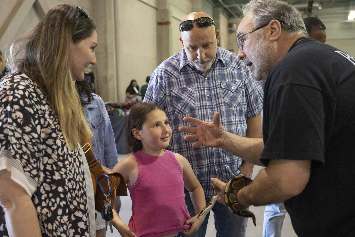 Event organizer Jeremy Epstein tells visitors about a snake during the Sacramento Reptile Show at Cal Expo in Sacramento on Sunday, April 19, 2026.