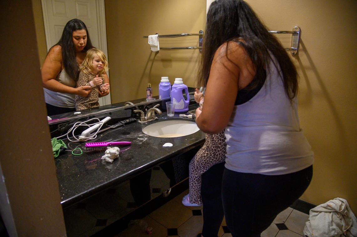 Lane’t Lynn, 24, lifts her daughter Kalaya Warren, 3, to help her wash her hands while staying at Americas Best Value Inn Friday, Jan. 31, 2020 in Sacramento.