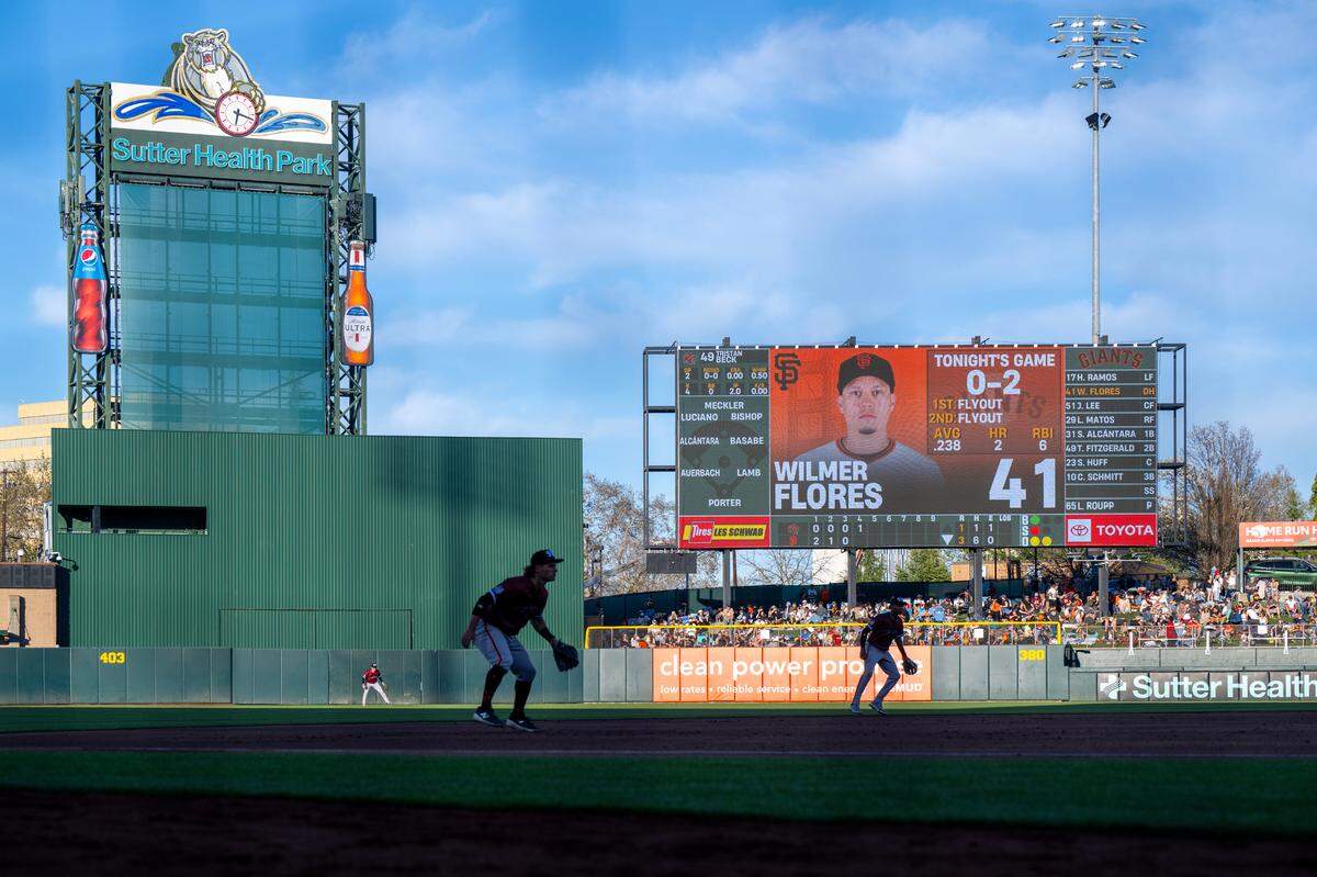 The new scoreboard in right-center field, which replaces the smaller one above the center field wall, presents stats on San Francisco Giants batter Wilmer Flores during exhibition game against the Sacramento River Cats at Sutter Health Park on Sunday in West Sacramento.