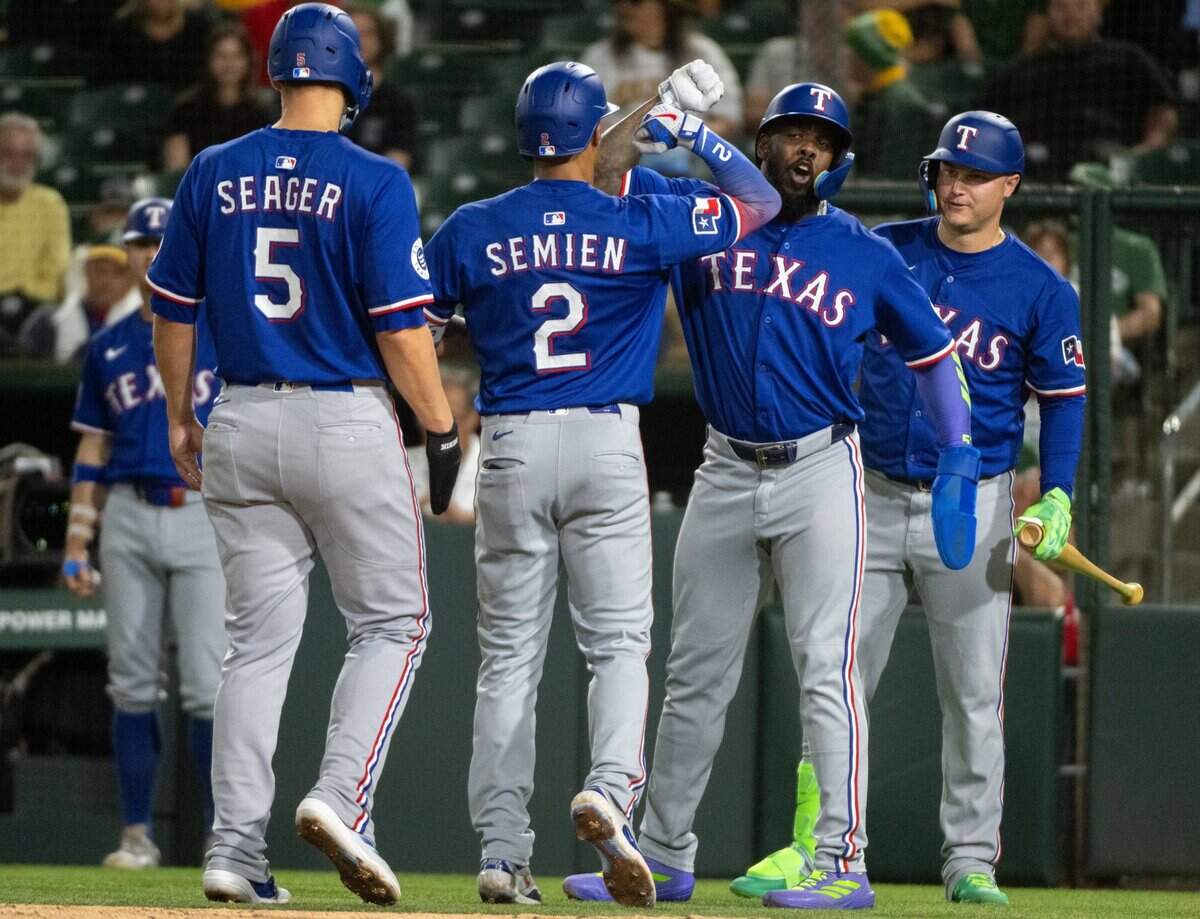 Texas Rangers second baseman Marcus Semien (2) celebrates with teammates after his three-run homer in the fifth inning against Athletics pitcher Osvaldo Bido during a game at Sutter Health Park in West Sacramento on Tuesday.