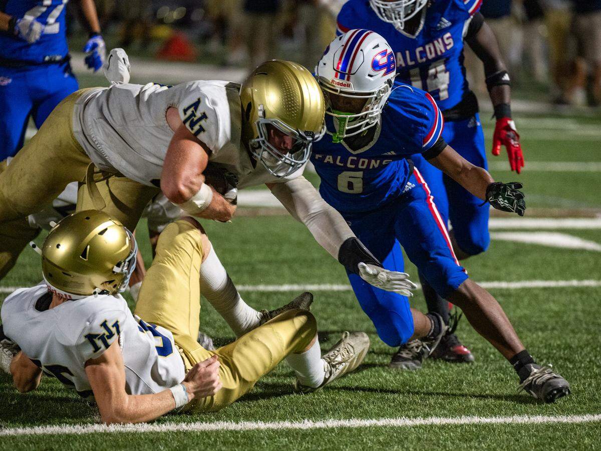 The Nevada Union Miners' Brandon McCallum (9) dives over the goal line past the Christian Brothers Falcons' Nasser McGee (6) for a touchdown in the second quarter in Sacramento on Friday.