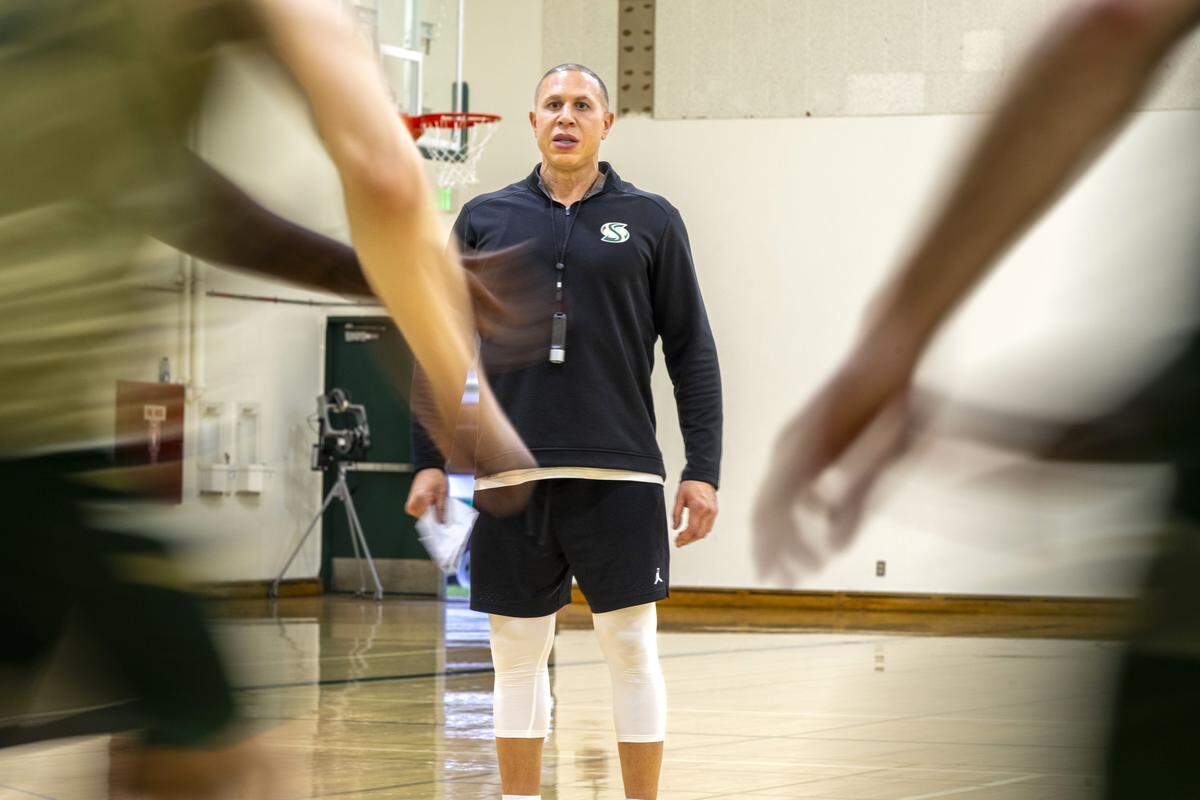 Sacramento State basketball head coach Mike Bibby runs a play during practice last month. 
