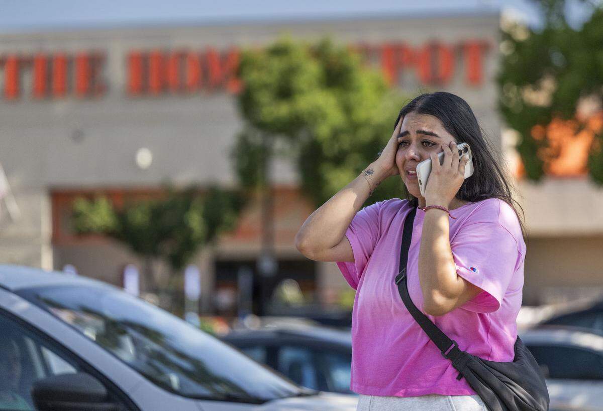 Andrea Castillo speaks to a relative after her husband, who she said was born in Sacramento, was taken into custody by masked uniformed men from the U.S. Border Patrol at the Home Depot on Florin Road near Highway 99 in south Sacramento on Thursday, July 17, 2025. Castillo said that her husband called her saying he was recording the men on the parking lot. ”If he wasn’t brown, he wouldn’t have been questioned,” Castillo said.