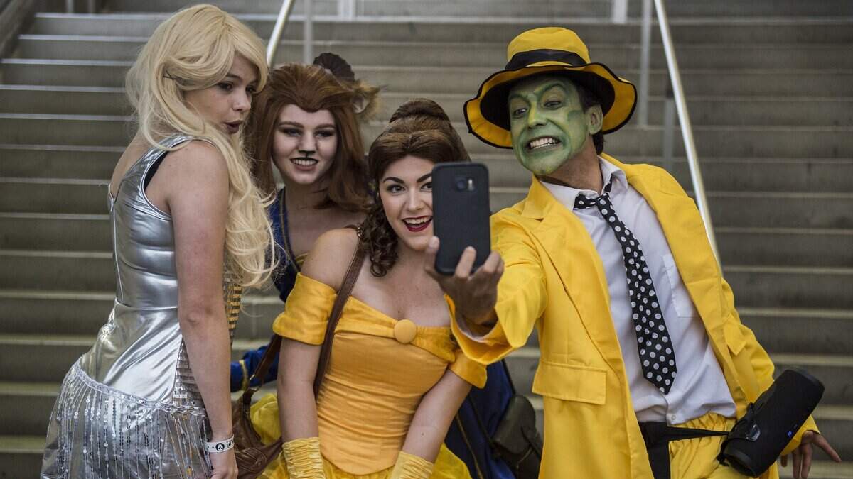 David Perez, right, poses as the character  "The Mask" for a selfie with, from left, Gabby Gutierrez, who dressed as "Tina," from the movie The Mask, as Kameron Skellenger, dressed as "The Beast" and Corine Pellegrini as "Belle," from Beauty and the Beast. They were attending SacAnime at the Sacramento Convention Center in Sacramento, Calif., on Sunday, Jan. 7, 2018.