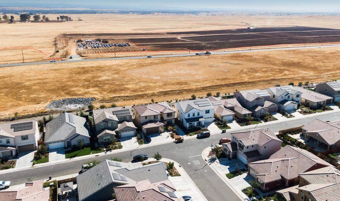 Rancho Cordova homes stand in the foreground as the ground breaking of Braden, a new planned community in Sacramento County, takes place Thursday, Sept. 26, 2024.