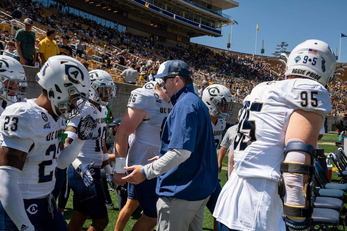 UC Davis Aggies head coach Tim Plough greets his players as the take the filed before a game against the California Golden Bears on Saturday, Aug. 31, 2024, at Memorial Stadium in Berkeley. UC Davis in 2025 will play three nationally televised ESPN games.