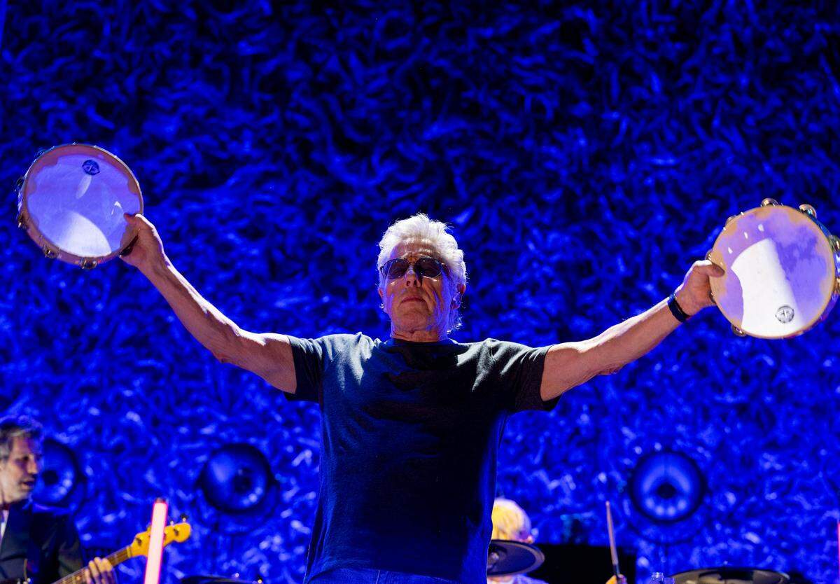 Roger Daltrey holds out tambourines while performing with The Who in Sacramento on their North American tour Wednesday at Golden 1 Center.