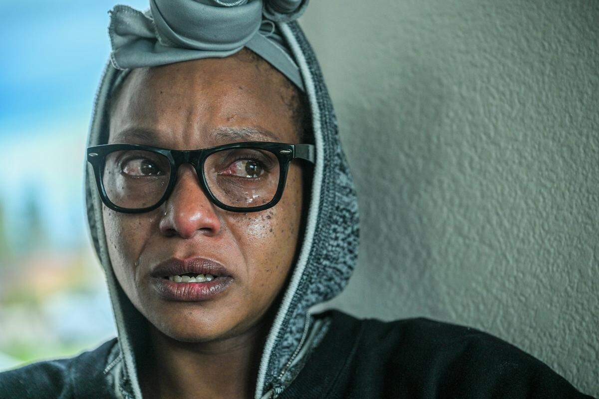 Tears stream down the face of Tanika Williams, 38, who stepped away from her family in the Quality Inn lobby because she didn’t want them to see how upset she was in March. She was running out of options for housing in Sacramento and trying to sort out where to go next. She and her family left later in the month for San Bernardino, hoping to find better services.