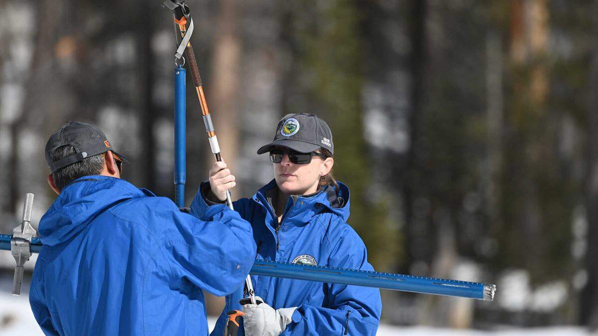 From left, Department of Water Resources engineers Derick Louie and Jordan Thoennes conduct the third snow survey of the 2025-26 season at Phillips Station on Friday, Feb. 27, 2026. State officials said the survey measured snowpack at 47% of average this time of year as California remains below normal despite recent storms.