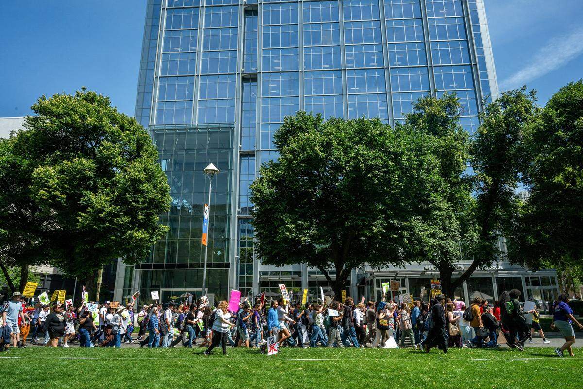 Hundreds of demonstrators participate in the “A Day Without Immigrants” 20th anniversary march along Capitol Mall in Sacramento as they head toward the John E. Moss Federal Building, to protest ICE on Friday.