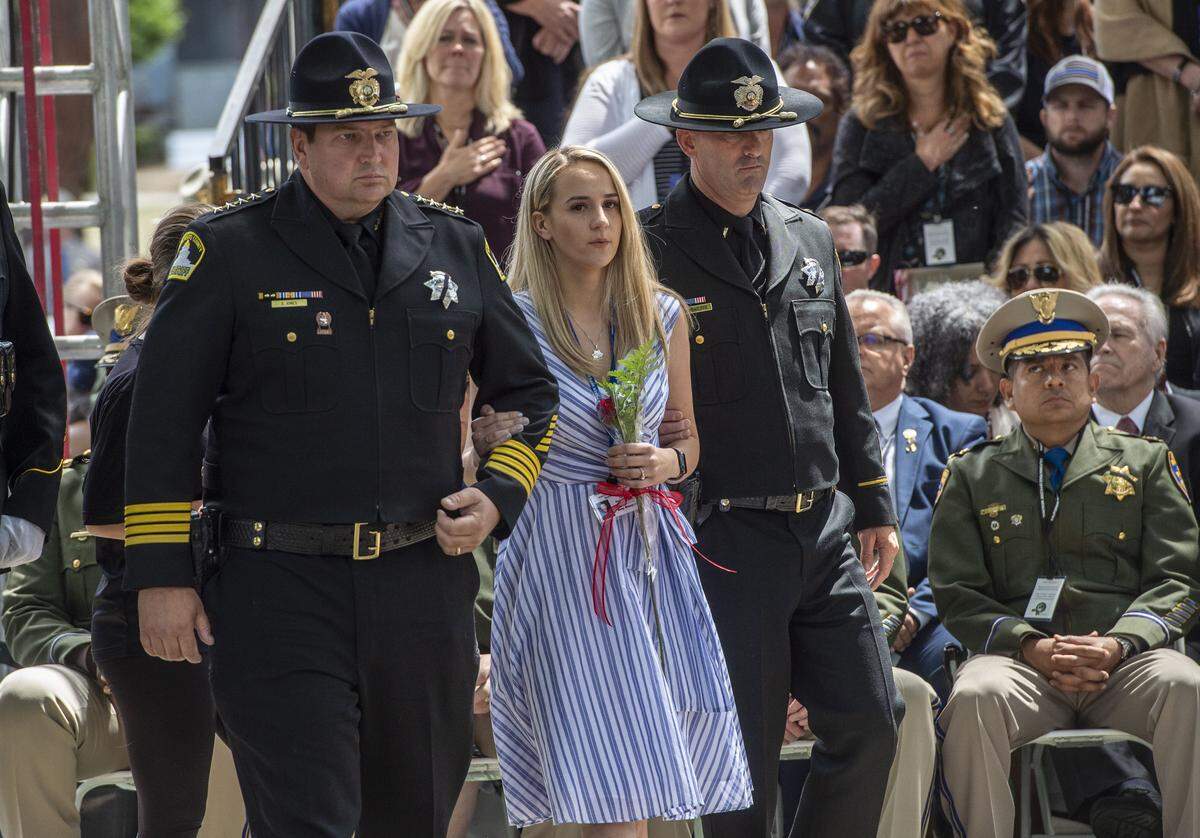 Amy Stasyuk, wife of fallen Sacramento County deputy Mark Stasyuk, is escorted by Sheriff Scott Jones during the California Peace Officers’ Memorial Ceremony in 2019. Stasyuk was one of four deputies killed by gunfire during Jones’ tenure.
