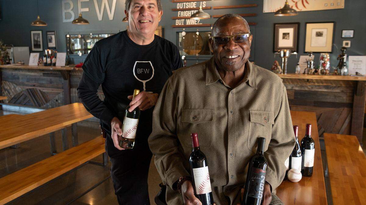 Local baseball great Dusty Baker, the manager for the Houston Astros – and former manager of the San Francisco Giants – sits with winemaker Chil Brenneman inside of the tasting room at the Baker Wine Family in West Sacramento in December.