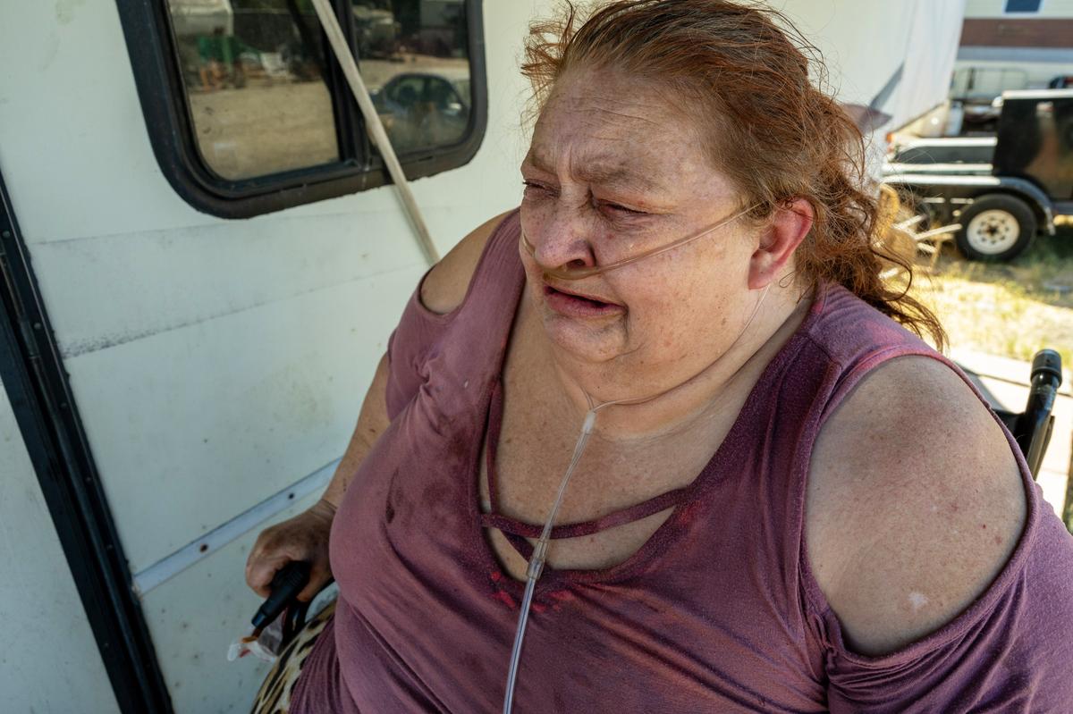 Tears stream down the face of Camp Resolution resident Shonn Adams, 55, who depends on oxygen to live with chronic obstructive pulmonary disease, as she describes the uncertainty of their homeless encampment on Monday. “People don’t care anymore,” she said. “Supreme Court what makes it illegal to sleep in public. What are we supposed to do?”