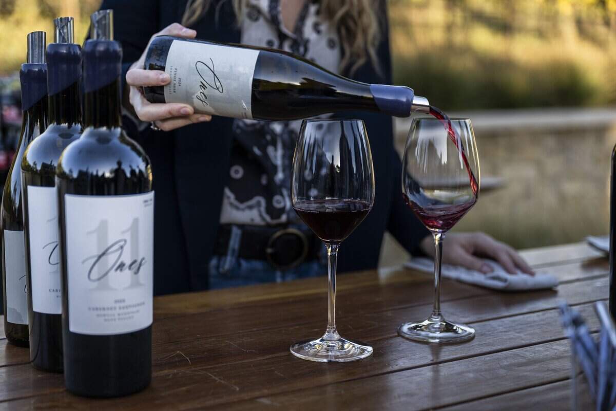 Amber Brander pours glasses of the Ones 2024 Pinot Noir during a private unveiling of two new vintages from the brand of Sacramento Kings center Domantas Sabonis and wife Shashana in the Napa Valley on Saturday.